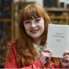 University of Otago student Caitlin Duff (19) holds a book of poems by Dunedin conscientious...