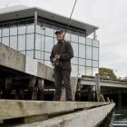 Kelvin Sampson, of Waikouaiti, fishes off the Steamer Basin pontoon (below). PHOTOS: GERARD O’BRIEN