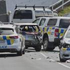 A police photographer takes photos at the scene of a car crash which left a police dog injured...