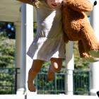 Lucy Frisby had fun with her teddy bear on Sunday afternoon at Queens Park. PHOTO: LAURA SMITH