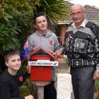 Showing off their Anzac letterbox decorations are brothers Devon and Dartanyon Richards with...