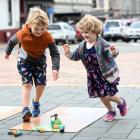 Siblings Liam (5) and Billie (3) Tucker, of Dunedin, take part in ‘‘Corona Bowling’’, during...