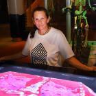Otago Museum science communicator Catriona Gower with an interactive exhibit showing, in red...