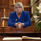 President of the Victoria League in Otago Christine Bell with a condolence book at St Paul’s...