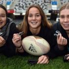 St Hilda’s Collegiate rugby players (from left) Anya Clark (15), Jaymee Meffan (16) and Anna...