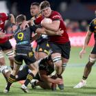 Crusaders captain Scott Barrett is tackled by Chiefs captain Brad Weber during Saturday's Super...