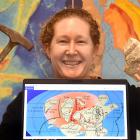 GNS Science geologist Dr Rose Turnbull with a lump of granite from Fiordland, and a graphic...