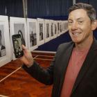 Nick Leith, deputy principal at Casebrook Intermediate School, scans the QR code on the photo of...