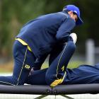 Physiotherapist Brett Harrop works on injured all-rounder Nathan Smith during an Otago Volts team...