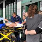 Countdown staff comfort each other as a stabbing victim is rushed to an ambulance outside the...