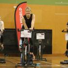 Kate Webster rides in the North Otago Plunket ‘‘Lycra for Littlies’’ spin-a-thon flanked by her...