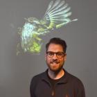 Otago Museum marketing co-ordinator Charles Buchan with a projected image of Jamie Fraser’s...