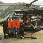 Celebrating the successful mission at the Mount Cook rescue base helipad are (from left) former...