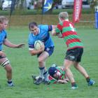 Wakatipu openside flanker Dave Fraser gives Matakanui Combined's Luke Hume the flick, with team...