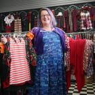Shop on Carroll team leader Erin Dellow holds an array of clothing in the shop on Tuesday. PHOTOS...