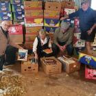 Organising books for the Rotary Club of Taieri's upcoming book sale are (from left) Phil Farquar,...