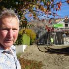 Meadowstone resident David Evans in front of a two-storey unit being built in the Roys Bay Estate...