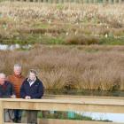 Standing overlooking the new Waipahi Wetland are (from left) project manager Shane Bocock, and...