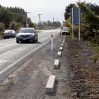Concrete kerb blocks have been installed on a section of Miller Rd, Momona, to protect new...