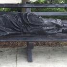 The Homeless Jesus sculpture lies on a bench at the campus of King’s University College at...