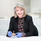 Dr Jill Haley holds a Spratt’s dog cake fragment from the Canterbury Museum collection. PHOTO:...