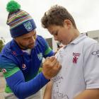 Mairehau Primary School pupil Kalo Willetts gets his school jersey signed by former Warrior Ruben...