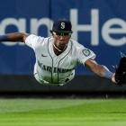 Seattle Mariners leftfielder Shed Long jun dives for a ball during his team’s Major League game...