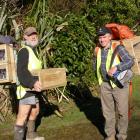 South Otago Forest &amp; Bird volunteers Roy Johnstone (left) and Jim Young prepare to lay...