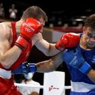Uladzislau Smiahlikau (red) of Team Belarus exchanges punches with David Nyika who won the...