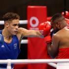 Youness Baalla (red) of Morocco defends as Kiwi Olympian David Nyika throws a punch. Photo: Getty...