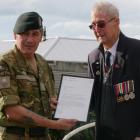 Lieutenant-colonel Tim Tuatini delivers a letter from the Chief of Army to congratulate (Peter)...