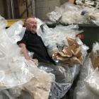 Otago Pellet Fires owner Martin Wilkes takes a break on plastic bags waiting to be recycled....