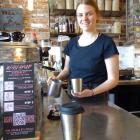 Urban Grind eatery and bar manager Jennifer Rynearson makes a coffee in a reusable and recyclable...