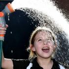 Taking her first drink of town-supply water in six months is Waikouaiti School pupil Charlee...