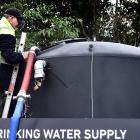 Filling up a water tank in Kildare St, Waikouaiti, this week is Steve Barnes, of Dynes Transport....