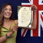 Sahitya Anand proudly displays her citizenship certificate after becoming a New Zealand citizen...