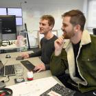 Intern-turned-developer Ryan Collins (left), compares notes with CloudCannon co-founder George...