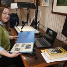Clutha District Council’s community heritage co-ordinator Tiffany Jenks works on her scanning...