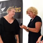 Otago coach Raylene Bates is presented with a special pin by Paralympics New Zealand chief...