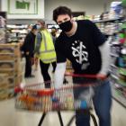 Student Volunteer Army Otago logistics officer Tom Yates shops for a client at New World Centre...