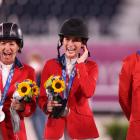 Laura Kraut, Jessica Springsteen and McLain Ward of Team United States pose with their silver...
