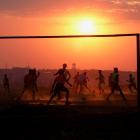 Locals play football on a dusty pitch in Soweto, South Africa. REUTERS
