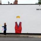 Children play next to a mural in Darlington, England, dedicated to British US Open winner Emma...
