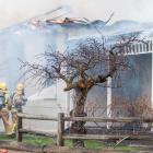 Fire crews fight to keep the blaze at the The Bank Ophir bed and breakfast under control...