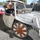 Kaka Point stand›up paddleboarder and corrugated iron sculptor Tony Somerville with the home...