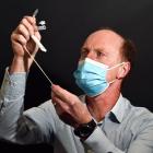 Examining the components of a rapid antigen testing kit is Joe Connolly, of Dunedin, who brought...