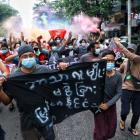 Protesters take part in a demonstration in Yangon on July 7 against the military coup and to mark...