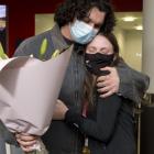 Long jump gold medallist Anna Grimaldi is greeted home by partner Felix McDonald at the airport...