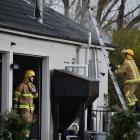 Firefighters at the scene of a house fire in Bainfield Rd. Photo: Laura Smith
