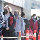 A queue of shoppers with masks in place wait their turn to enter Gardens New World in Dunedin...